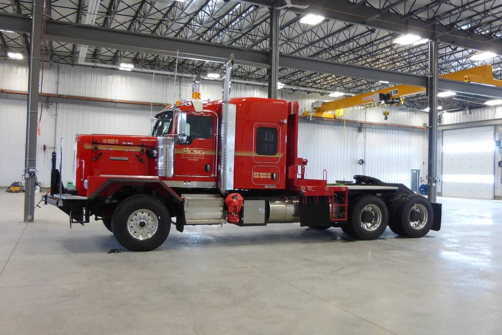 A red NCSG truck parked in a warehouse.