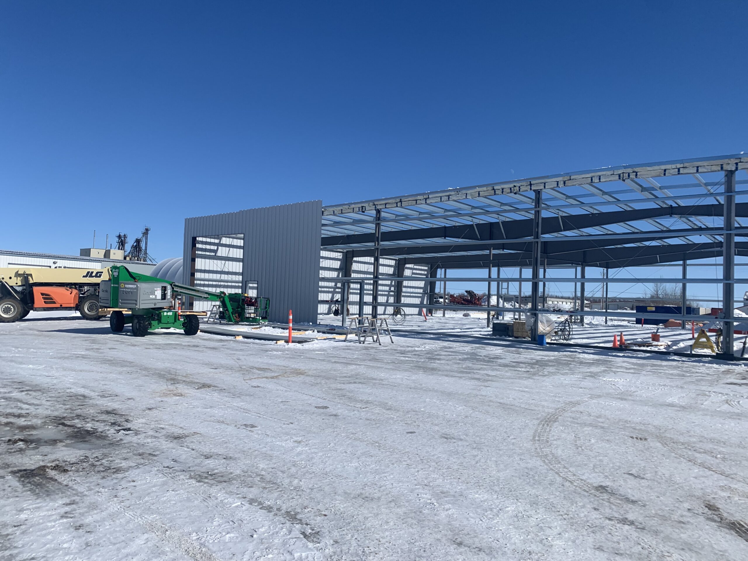 The exterior of an in-construction grey steel structure.