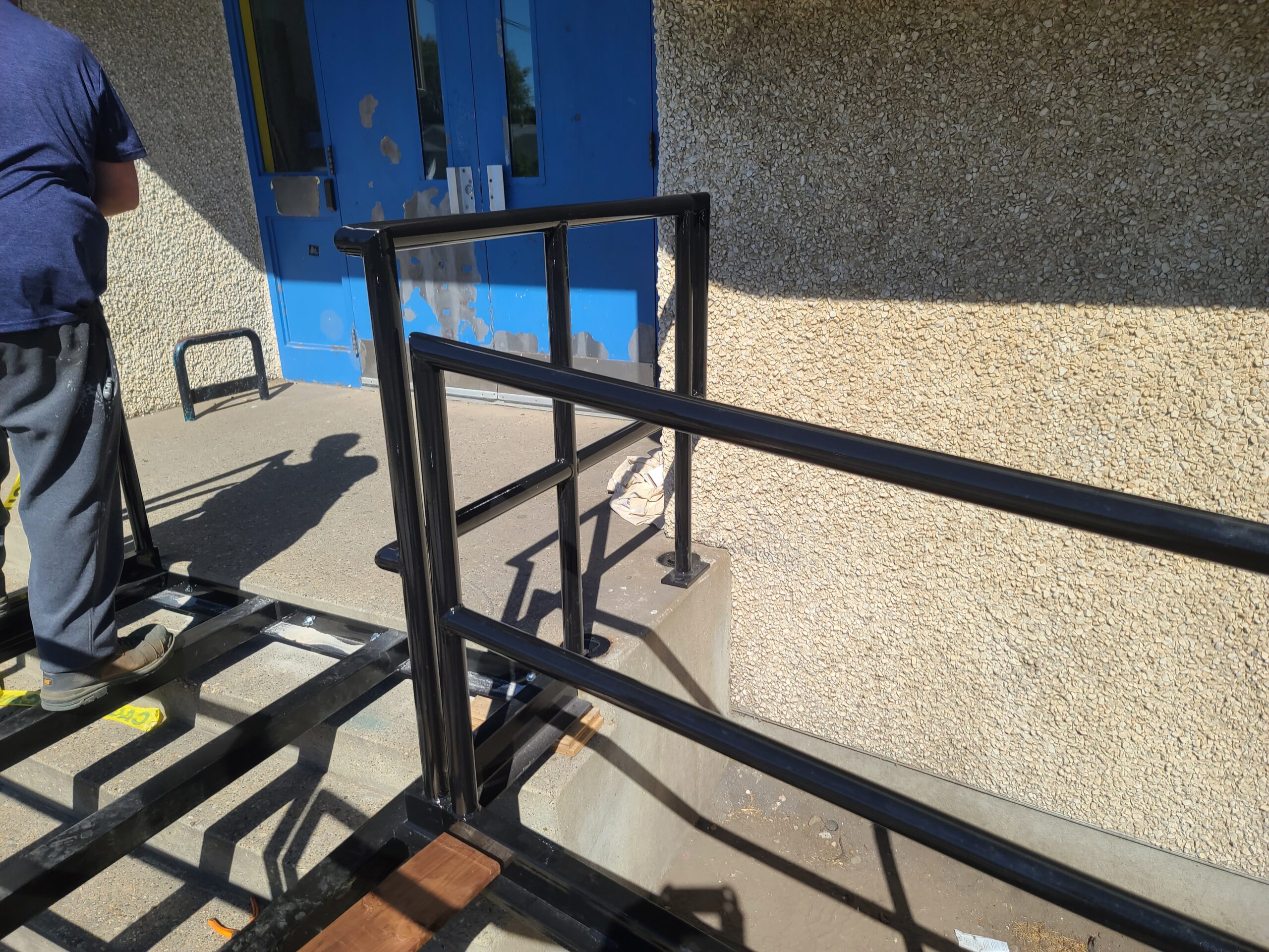 The hand rail of Redwater School's access ramp.