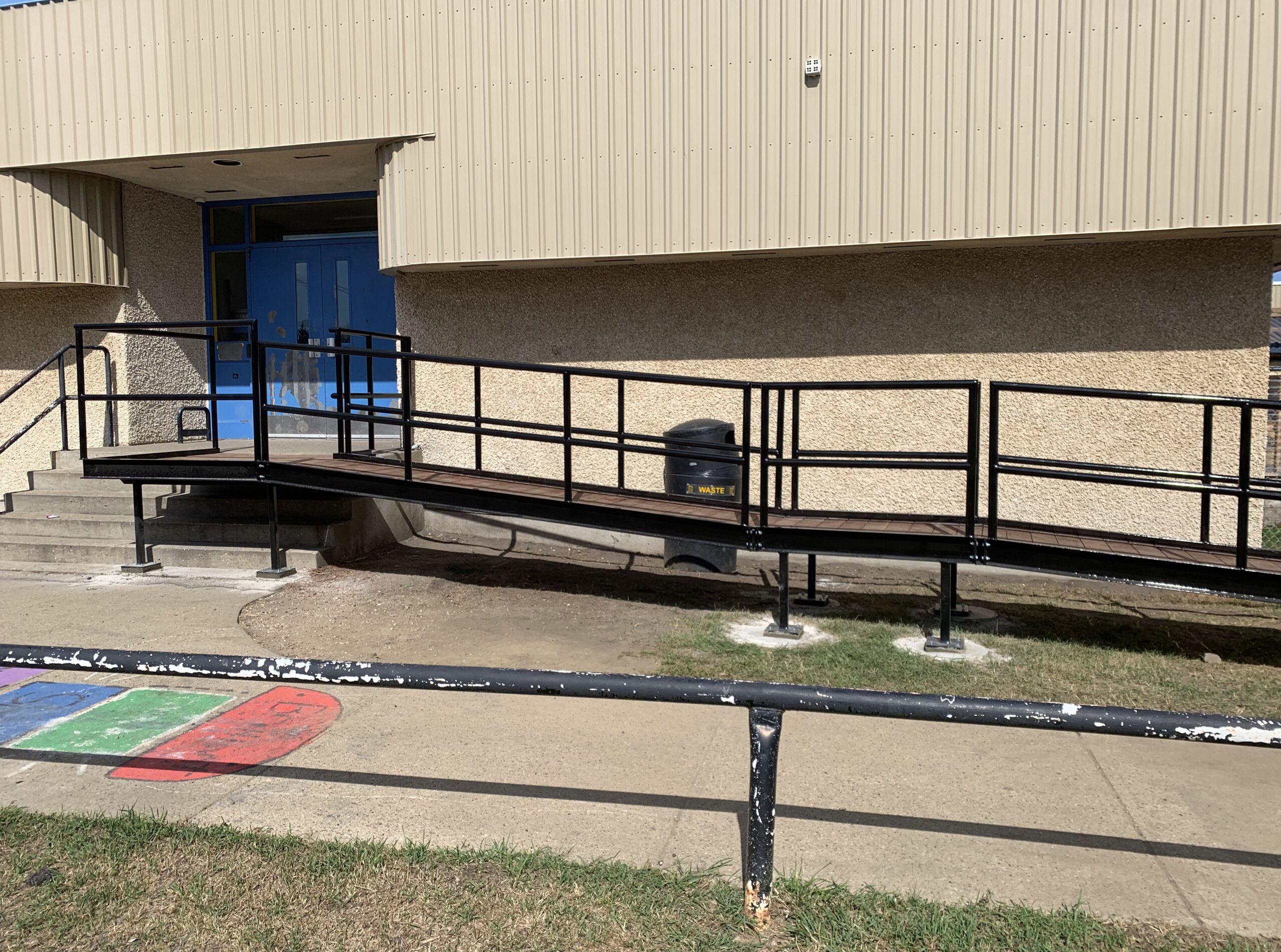 The access ramp built for Redwater School by Flynn Bros Projects reaches the blue front door of the school.