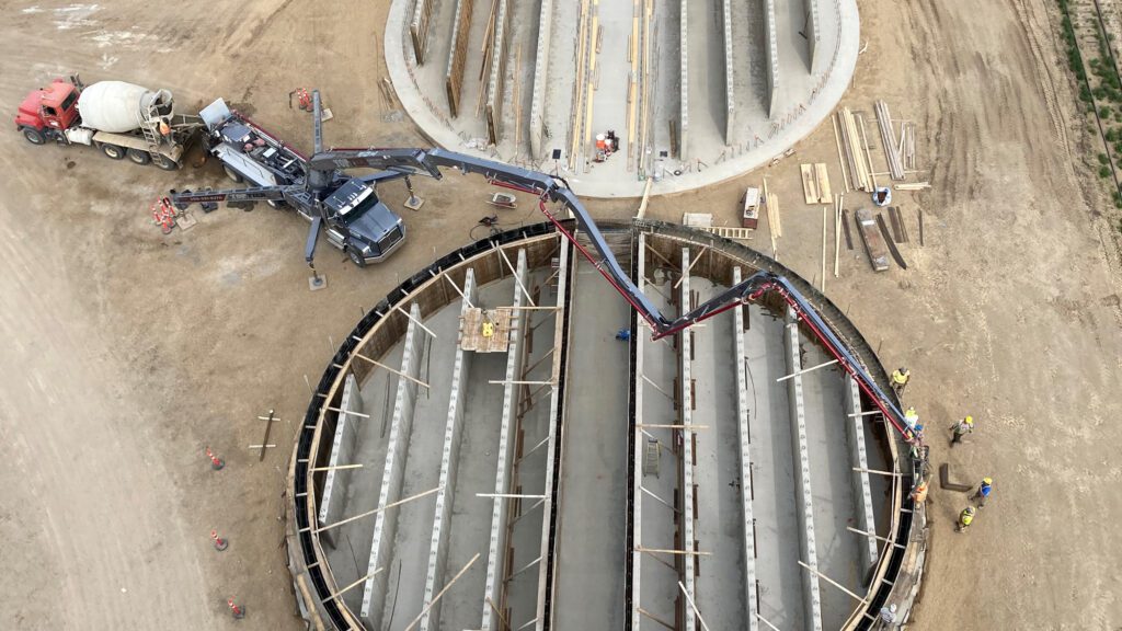 An aerial view of the foundation of a grain storage system in construction.